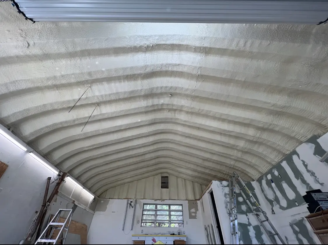 Spray polyurethane foam applied to the underside of a metal roof deck in Austell